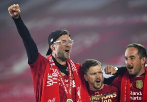 Media by Associated Press - Liverpool's manager Jurgen Klopp, left, celebrates following the English Premier League soccer match between Liverpool and Chelsea at Anfield Stadium in Liverpool, England, Wednesday, July 22, 2020. Liverpool are champions of the EPL for the season 2019-2020. The trophy is presented at the teams last home game of the season. Liverpool won the match against Chelsea 5-3. (Paul Ellis, Pool via AP)